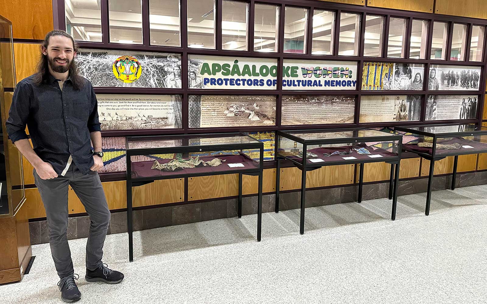 Graduate student Ben Hillerman with Apsaalooke exhibit