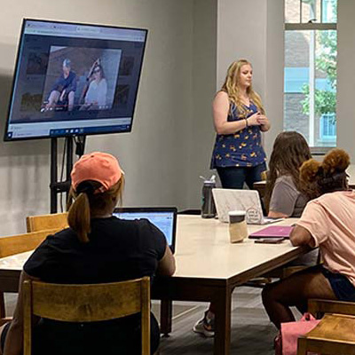 Student in the Collaboration Studio watch a presentation.